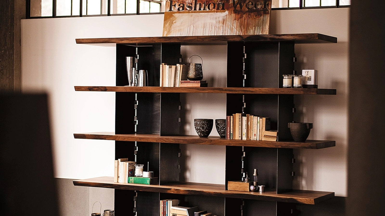 Libreria Brie in legno massello caratterizzata da due colonne costituite da carter in ferro intersecate da mensole con bordi anteriori naturali di Riva1920